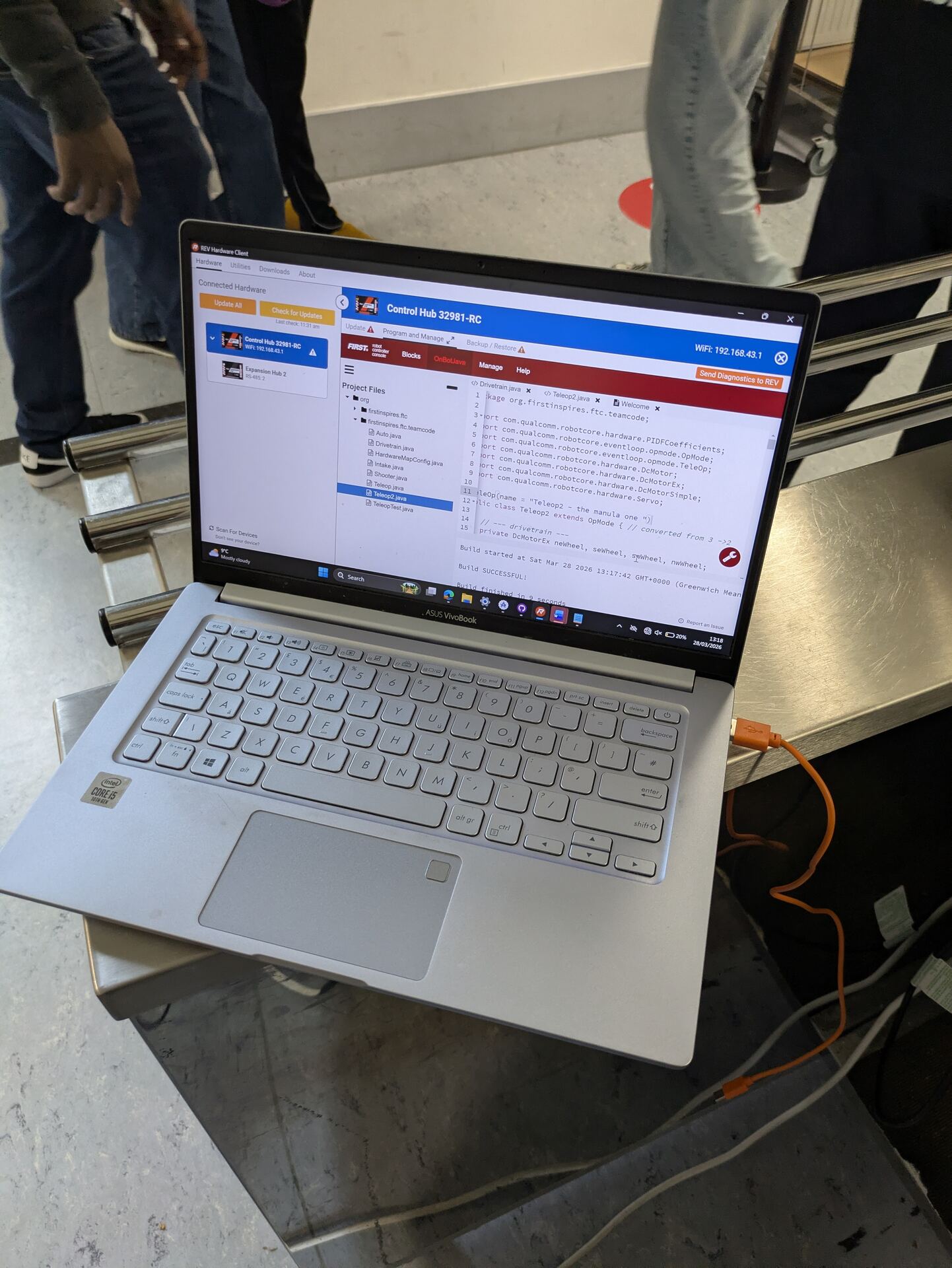 Team members programming the robot between matches